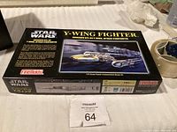 Closed box of Star Wars Y-Wing Fighter plastic model kit, black box with artwork and text, unopened.