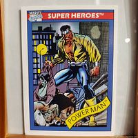 Front side of 1990 Marvel Power Man #12 trading card showing character in a city background with villains below.