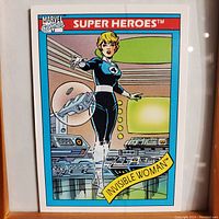 Front of the trading card showing Invisible Woman illustration, Marvel Comics logo, Super Heroes series name, and card number.