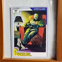 Front side of Marvel trading card showing Chameleon character seated in a chair under a lamp, full color illustration, labeled with 'Marvel 1991' and 'Super Villains' banners.