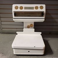 Full front view of the vintage scale showing white porcelain-covered steel body, weighing platform, and display with calibration labels.