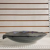 Side view of the large smoked quartz glass bowl showing the bubbles and stylized appliques along the rim.