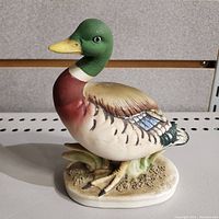 Front angle view of hand painted Lefton mallard duck figurine showing detailed paint and oval base