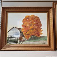 Full view of framed autumn oil painting with barn, large orange tree, and split rail fence.