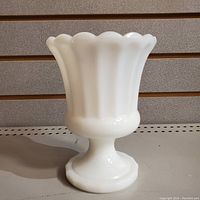 Full view of the vintage opalescent milk glass vase, showing its shape and base