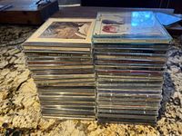 Two stacks of music CD jewel cases showing side titles and tops, totaling 46 CDs approximately