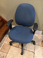 Front view of the blue office chair showing fabric seat, backrest, and black armrests.