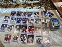 Cards arranged on white cloth showing multiple autographed player cards