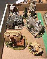 Top-down view of all six figurines in cardboard tray showing overall condition and paint detail.