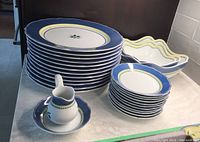 Photos showing nesting serving bowls with wavy edges and matching pattern.