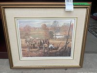 Full view of framed print showing the artwork, frame, and signature on the lower corner.