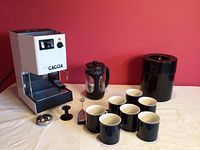 Full lot including Bravetti Gaggia espresso machine, Bodum French press, Kilo Vac coffee container, and set of seven dark blue mugs.