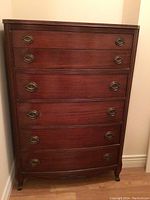 Front view of the full tall dresser showing six drawers and brass pulls.