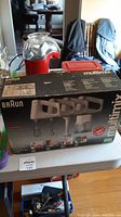 Box of Braun MultiMix M880 showing the product and attachments in photo.
