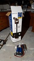 Burcam 1/3 HP cast iron sump pump in box with image of product on box.