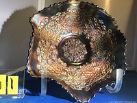 Front view of the cobalt blue carnival glass bowl showing intricate leaf chain and floral pattern with ruffled edges.