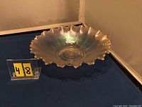 Side angled view of the white Nippon carnival glass ruffled bowl showing the iridescent finish and scalloped wavy edges.