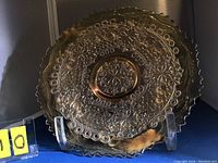 Front view of 9 inch carnival glass plate showing detailed leaf chain and floral patterns with marigold iridescence.