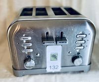 Front view of the Cuisinart toaster showing control buttons and levers for two sides, each with bagel, defrost, and reheat options.