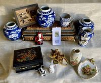 Overview of the lot showing all items including ginger jars, hand-carved box, bunnies, and assorted figurines.