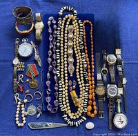Overview of all jewelry items laid out on blue cloth