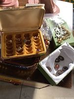 Overview image showing Mele ring case with costume rings inside, silver and gold chains, star charm bracelet, and a box containing multiple pairs of earrings.