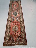 Full view of runner laid flat showing overall design, border and color palette