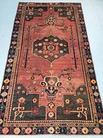 Full top view of rectangular wool rug showing overall geometric pattern and muted colors