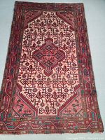 Full top view of the Persian Hamedan wool rug displaying its detailed geometric and floral patterns in red, pink, and brown tones with turquoise accents.