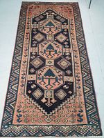 Full view of the rectangular Persian Lori wool rug showing tribal medallion pattern and borders.