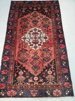 Full front view of rug showing overall geometric pattern, borders and color palette