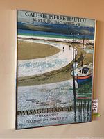 Full view of framed Galerie Pierre Hautot poster showing French coastal landscape with boat and curved shore. Vintage lithography from 1974-1975 period.