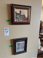 Photo showing both framed artworks hanging on the wall, top is the watercolor drawing, bottom is the religious print.