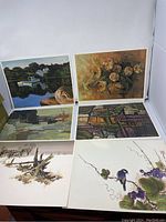 Six different art prints arranged for display showing a variety of styles including landscapes, still life, abstracts, and nature scenes.