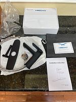 Full layout of all contents for the new HIMEGAO black matte faucet including packaging box, faucet, hoses, hardware, and instruction manual.