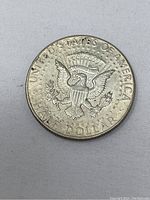 Reverse side of the coin showing the Presidential Seal with eagle and denomination.