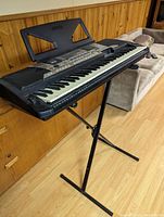 Front-right angle view of keyboard on stand with music rest