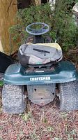 Front view showing Craftsman logo on mower’s front panel and steering wheel
