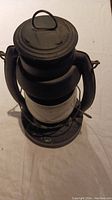 Top view of Embury Air Pilot #2 black metal oil lantern showing carrying handle and lid.