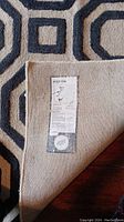 Close up of the rug label on the back side showing the Weston brand and care instructions.