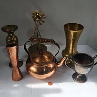 Photo showing brass and copper lot including vases, kettle, goblet and windmill figurine