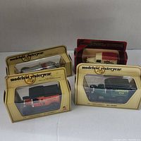 Four Models of Yesteryear Matchbox cars in original packaging, visible branding and retro designs, displayed in set formation on white surface.