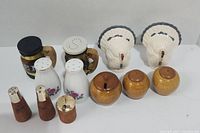 Photo showing all five sets of salt and pepper shakers together on a white surface.