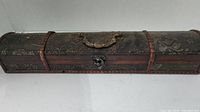 Front view of a decorative wood box with curved top, metal handle, and latch.