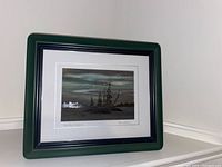 Framed carved stained glass art depicting a natural island scene at dusk, signed by Bruce Hall.