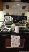 Full overview of baking supplies including stove top with Bundt pan, muffin pans, cookie sheets, recipe box, and other accessories.