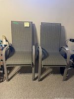 Two patio chairs side by side showing frame and fabric condition