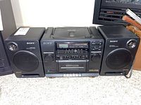 Front view of Sony CFD-442 stereo system with CD player, radio, cassette deck, and two speakers on side