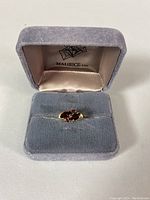 Ring displayed in Maurice Ltd branded box on velvet pad