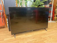Front view of 43 inch LG television on stand showing screen and frame